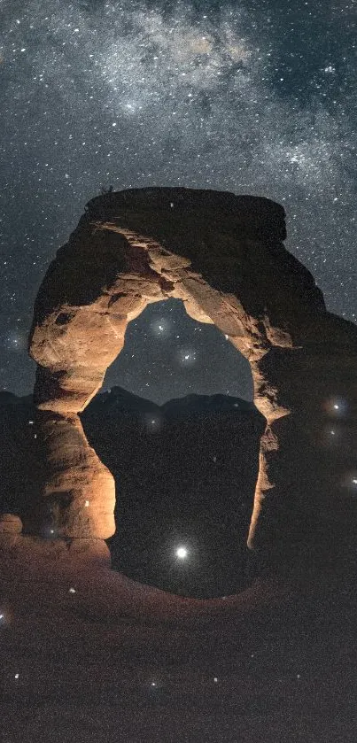 Majestic rock arch under a starry night sky.