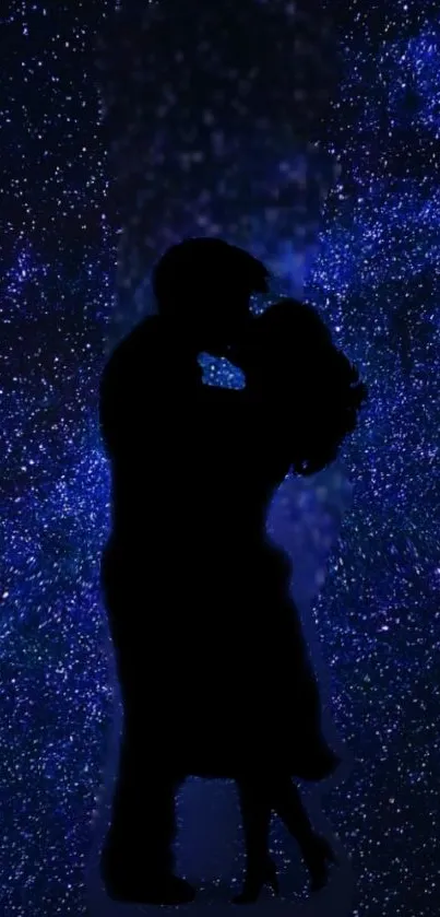 Silhouette of a couple against a starry, dark blue night sky.