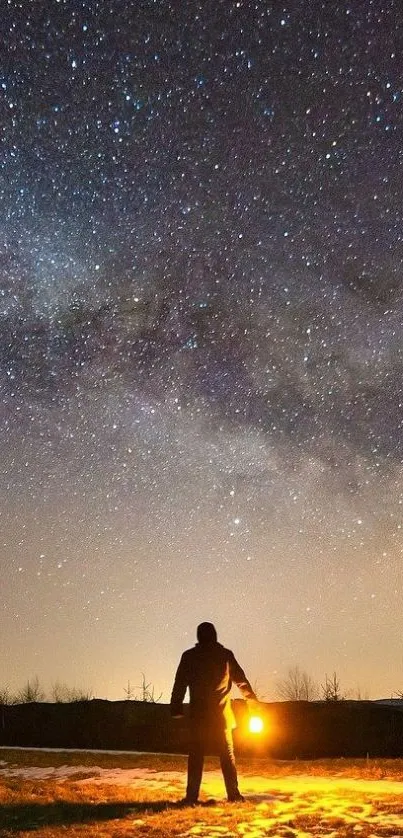 Person with lantern under starry sky showcasing Milky Way.