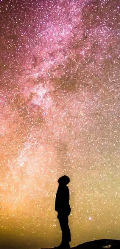 Silhouette gazing at a colorful starry night sky with vibrant cosmic colors.