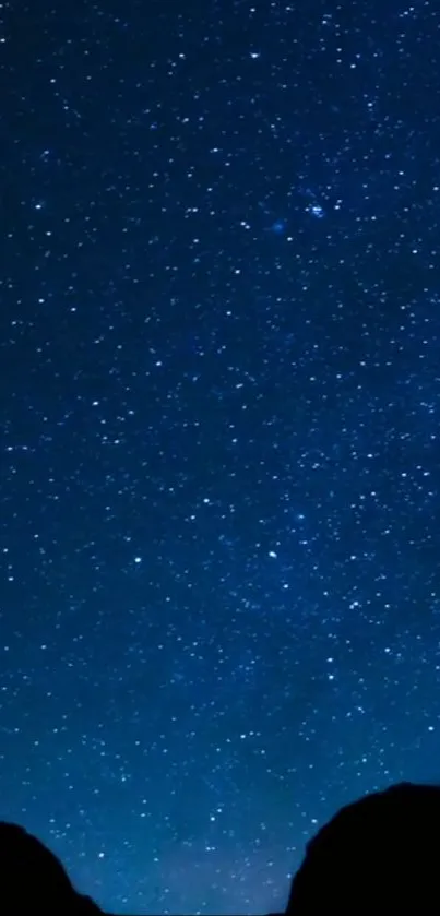 Starry night sky wallpaper with a deep blue hue.