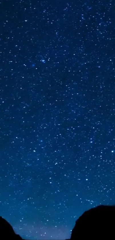 Starry night sky wallpaper with a dark blue hue and scattered stars.