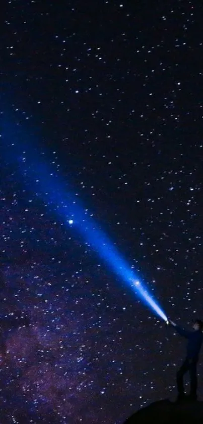 Silhouette under a starry sky with a blue light beam.