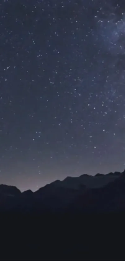 Starry night sky over mountains wallpaper.