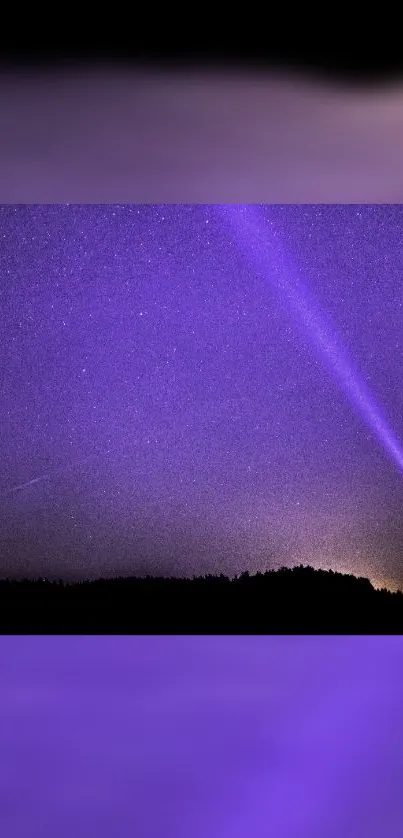 Starry night with purple sky and silhouetted figure holding a light beam.