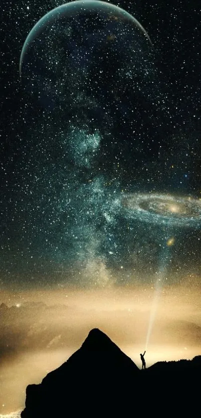 Night sky with stars, galaxy, and silhouetted person on mountain.