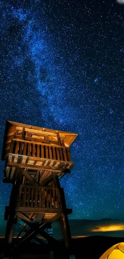 Starry night sky with wooden tower and glowing tent.