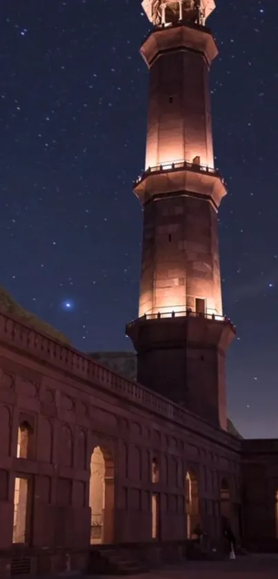 A majestic tower illuminated under a starry night sky.