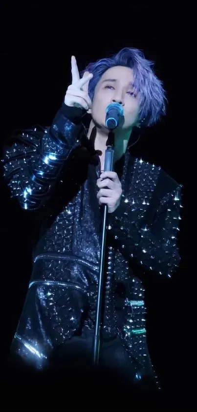 Dynamic singer on stage with purple hair and sparkling attire.