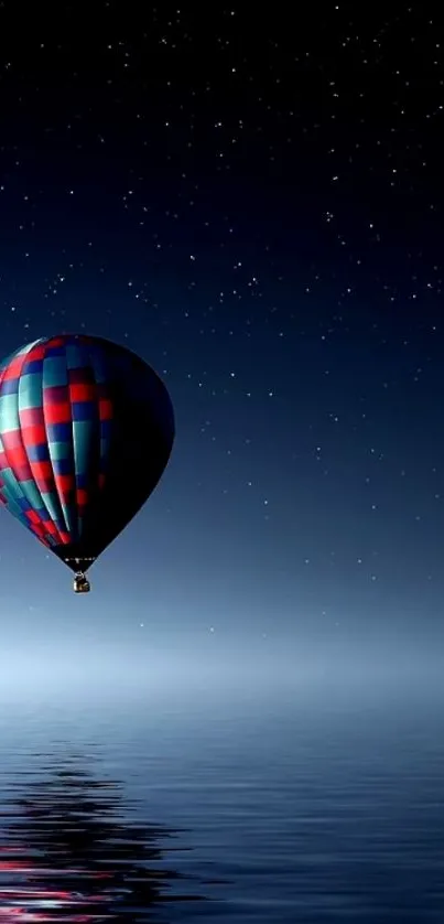 Hot air balloon reflecting on starry night sky.