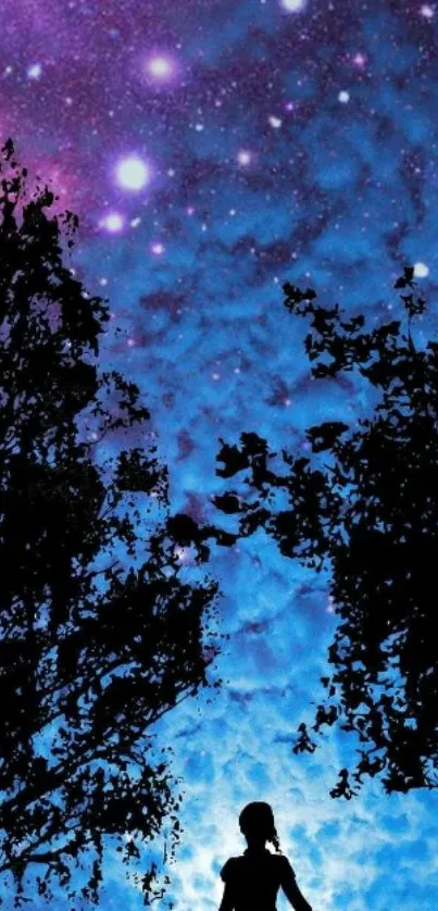 Silhouette of a person under a purple starry night sky with trees.