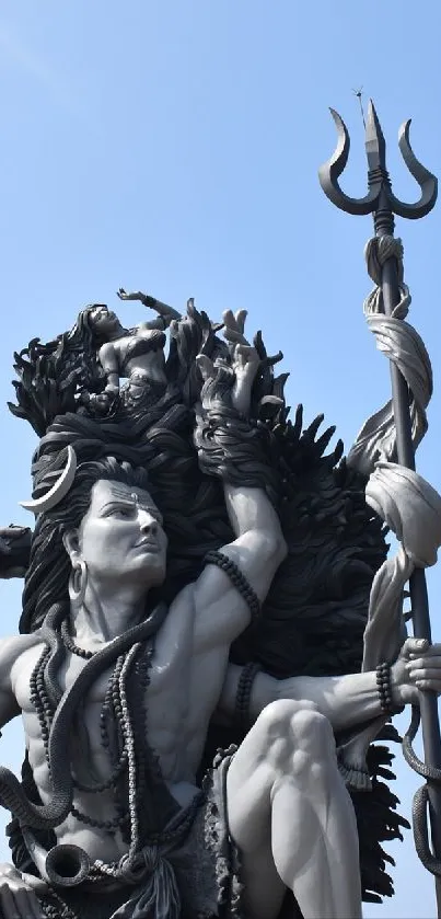 Monumental statue set against a bright blue sky background.