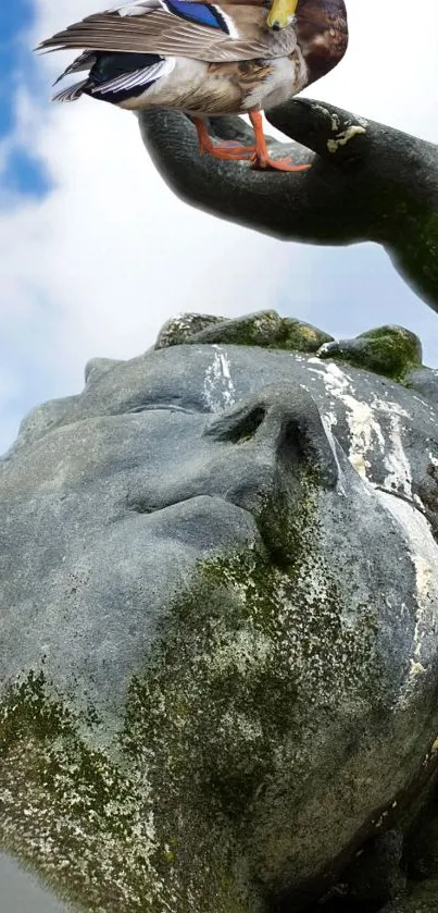 Stone statue with moss, duck perched on hand, serene sky backdrop.