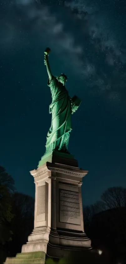 Statue of Liberty illuminated under a starry night sky.