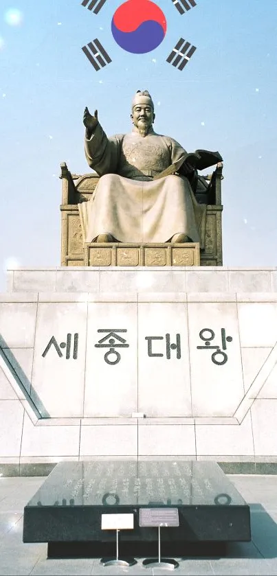 King Sejong statue with South Korean flag over blue sky.