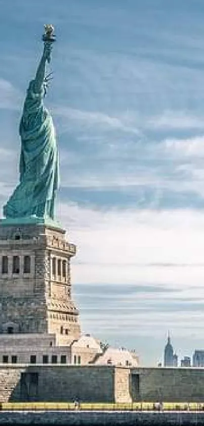 Statue of Liberty with NYC skyline and sky.