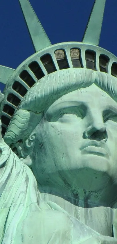 Close-up of Statue of Liberty against a blue sky.