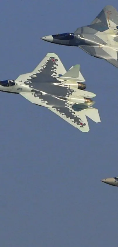 Four stealth fighter jets soaring through blue skies with aerodynamic precision.