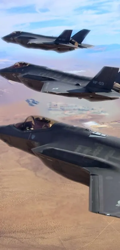 Three stealth jets flying in formation over a desert landscape.