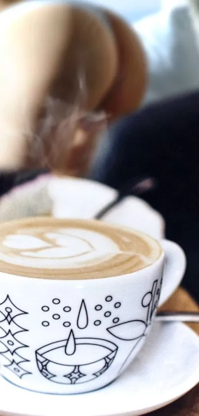 Steamy latte with intricate cup design.