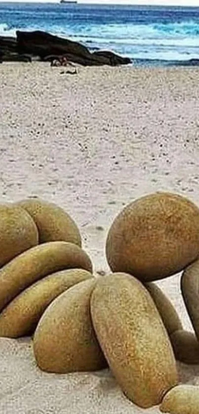 Stone sculpture on a sandy beach with the ocean.