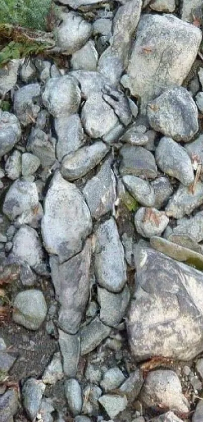 Stone artwork forming a human silhouette amidst rocks.