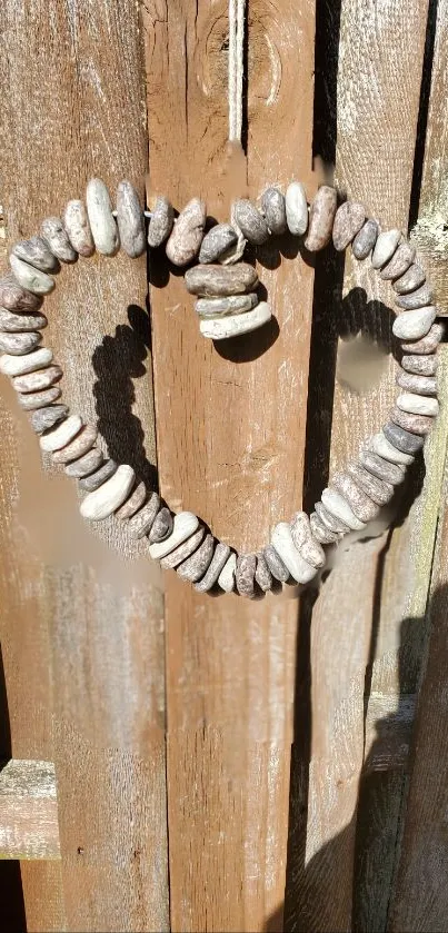 Heart-shaped stones on a brown wooden fence.