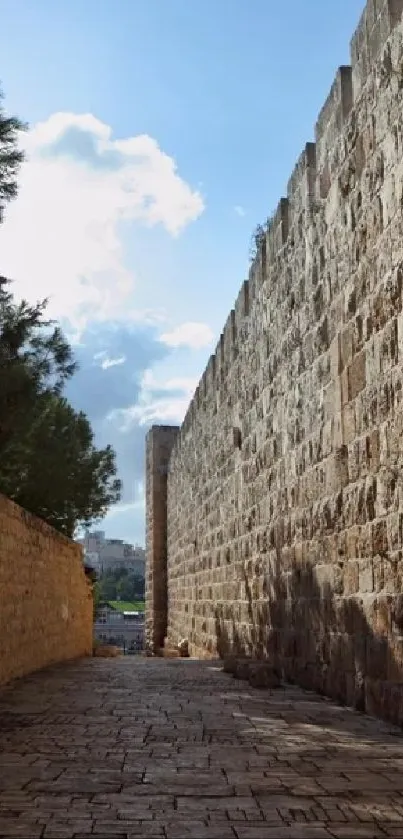 A stunning stone wall leading to a clear blue sky on a mobile wallpaper.