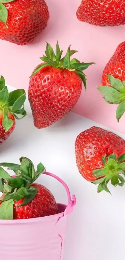 Strawberries scattered on a pink backdrop.