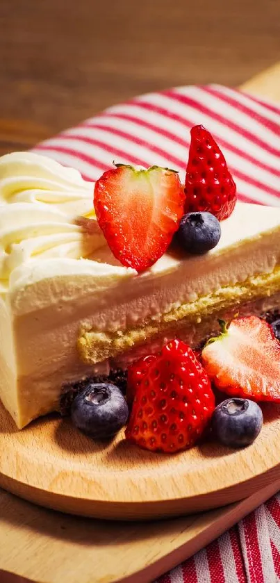 Close-up of a cake slice with strawberries and blueberries.