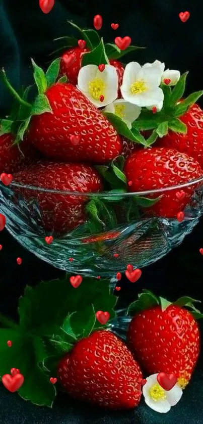 Crystal bowl with strawberries and tiny flowers on a dark background.