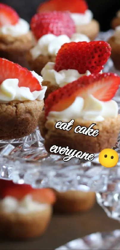 Strawberry-topped mini cakes on a crystal stand.