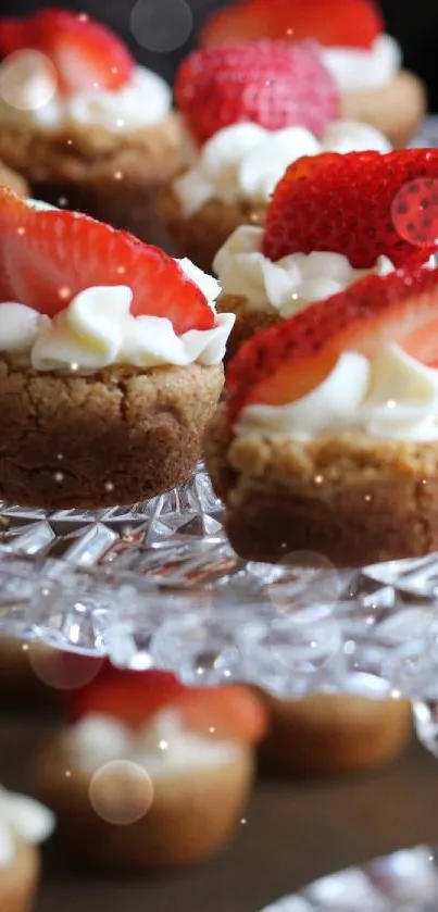 Strawberry desserts with cream on a crystal stand for a sweet display.