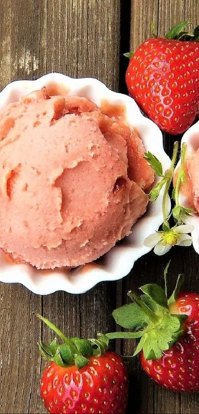 Strawberry ice cream scoops with fresh strawberries on a wooden table.