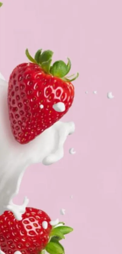 Strawberry with milk splash on pink background.