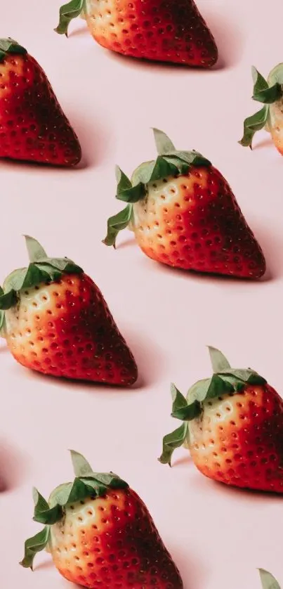 Patterned strawberries on a light pink background wallpaper.