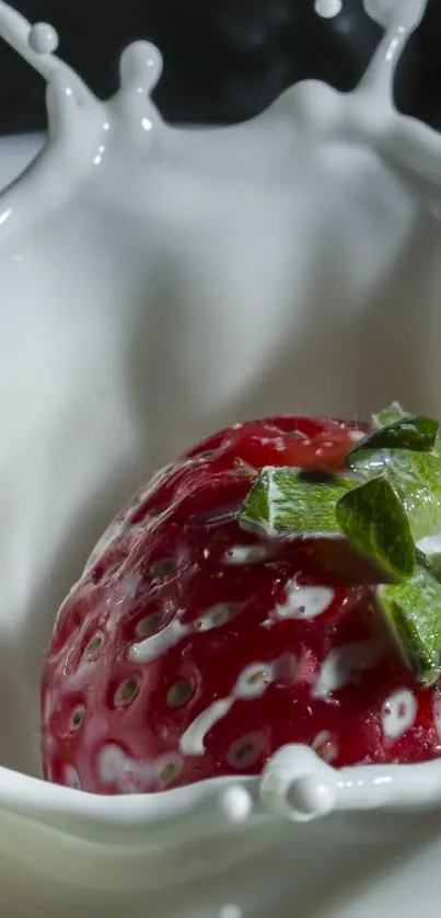 Strawberry splashing in milk with droplets suspended mid-air.