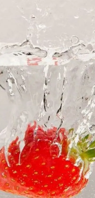 Splashing strawberry creating vibrant water art.