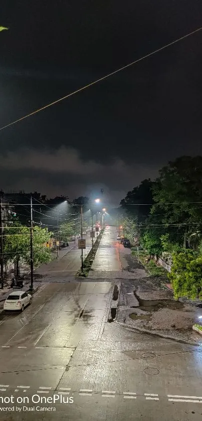 Nighttime view of a city street with streetlights and trees, captured by OnePlus.