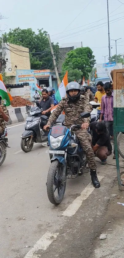 Motorcyclists wearing camouflage and waving flags in a lively street scene.