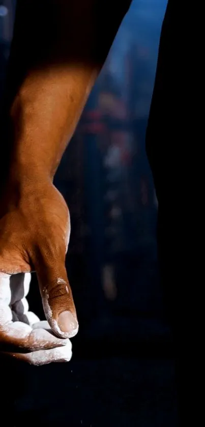 Close-up of a hand with chalk on a dark background.