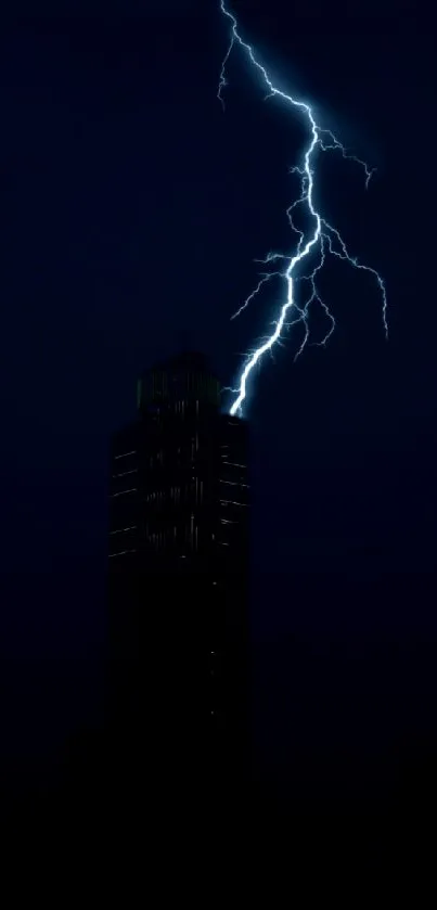 Nighttime cityscape with lightning striking a tall building against a dark blue sky.