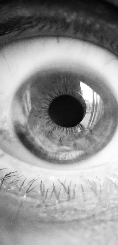 Monochrome close-up of a human eye, capturing intense detail and reflection.