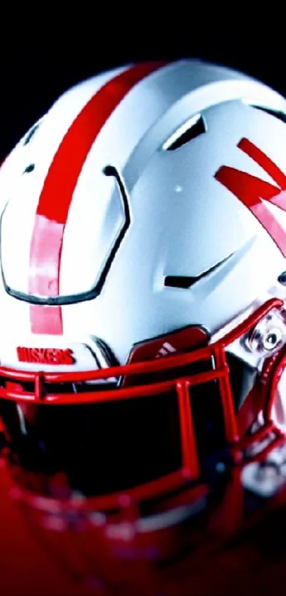 Red and white football helmet with bold design on wallpaper.