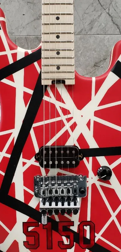 Red guitar with black and white lines on a marble background.