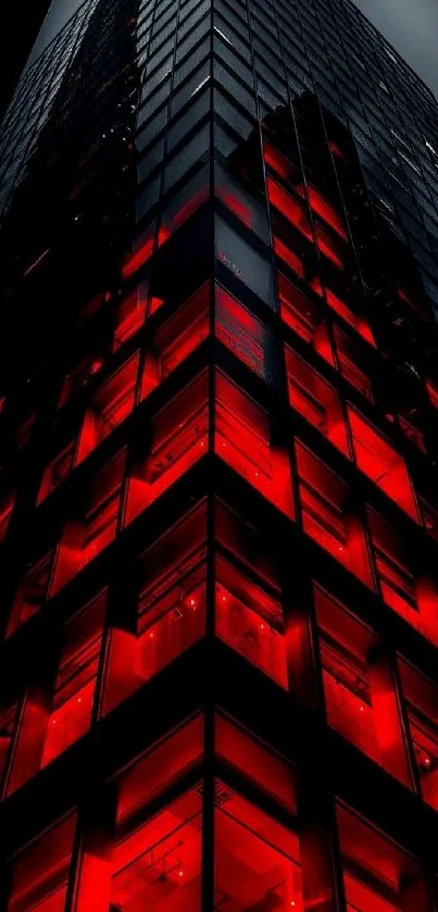 Red-lit skyscraper against a night sky