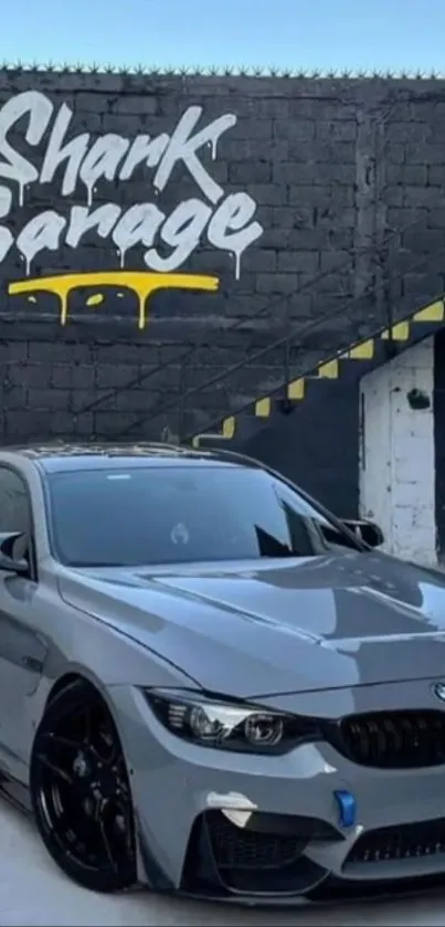 Sleek car parked in front of Shark Garage with striking graffiti.
