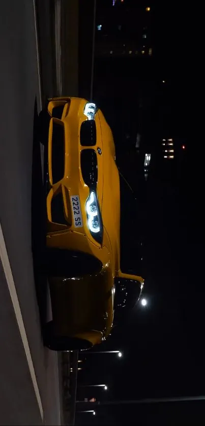 Yellow sports car at night with glowing city lights.