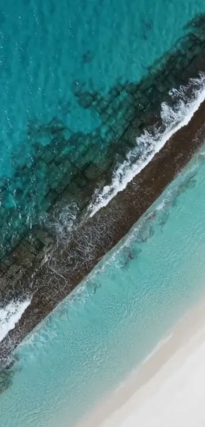 Aerial view of turquoise beach with waves gently crashing onto the shore.