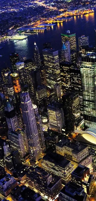 Aerial view of illuminated cityscape at night with vibrant lights.